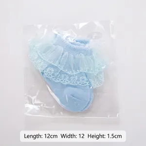 Light blue infant lace socks made of combed cotton in transparent retail packaging