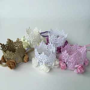 Detail of five baby lace crown headbands in gold, white, lilac, and pink with floral accents