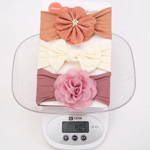 3-piece baby headband set with soft nylon bows and chiffon flowers on a light scale