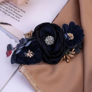 Détail du bandeau rose en satin bleu marine avec strass et perles de baies dorées