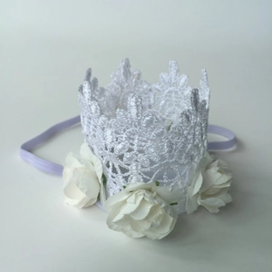 Detail of baby lace crown headband with white faux roses and purple elastic band