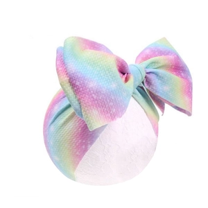 Rainbow gradient baby headband featuring waffle knit texture and a large bow design