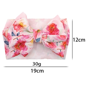 Detail showing pink floral baby bow headband with 19cm width and 12cm height dimensions