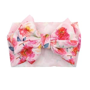 Detailed view of baby pink headband featuring vibrant watercolor floral patterns