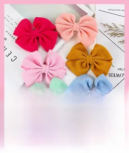 Detail view of six waffle fabric candy-colored hair bow clips for girls and babies