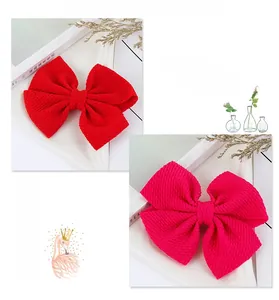 Detail of red and magenta waffle fabric bows showing textured material and layered design