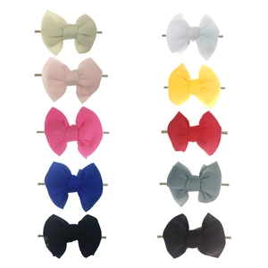 Detailed view of ten colorful chiffon bow headbands displayed in a neat grid arrangement