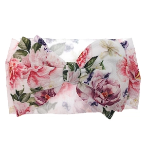 Detailed close-up of floral print baby headband featuring a soft oversized fabric bow