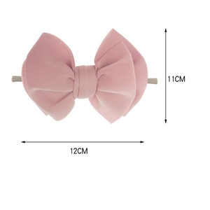 Detail of 11cm pink fabric layered bow headband with soft space cotton texture