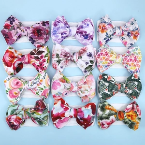 Detailed grid view of 12 printed bow headbands for babies with floral patterns