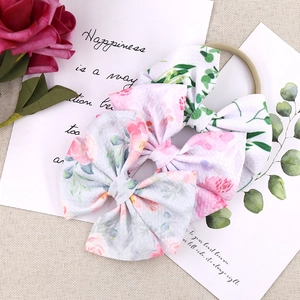 Set of two floral bow headbands for baby girls with pink patterns and soft nylon band
