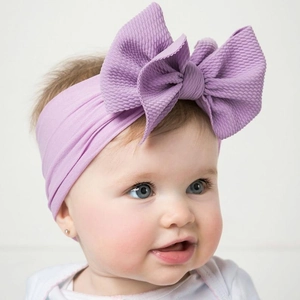 Detail of light purple baby headband with soft waffle knit textured oversized bow