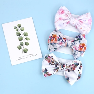 Three-piece set of soft bow baby headbands featuring vibrant floral print patterns