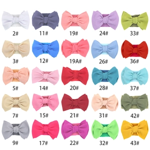 Catalog view of 25 colorful soft nylon baby headbands with large textured bow details