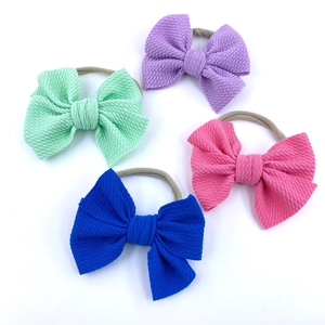 Set of four textured waffle fabric baby bow headbands with soft elastic nylon bands