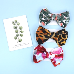 Detailed set of three soft baby headbands with leopard, floral, and watercolor prints
