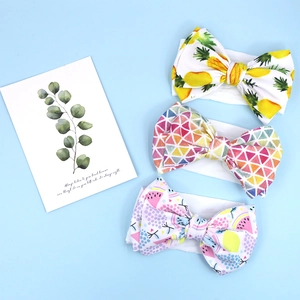 Three baby headbands with pineapple, geometric and fruit patterns on blue background