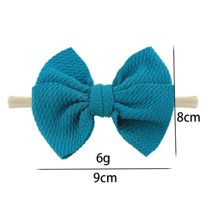 Deep teal nylon headband for baby girls with textured knit bow and size measurements