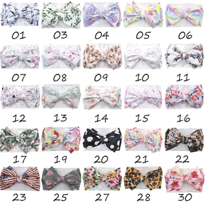 Collection of 25 colorful baby headbands with large bows in various vibrant patterns