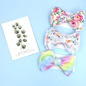 Detailed set of three baby headbands with floral and rainbow graffiti bow patterns