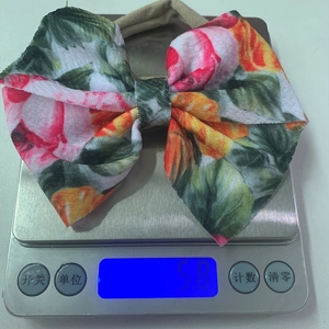 Detail shot of a soft floral bow baby headband showing lightweight 5.8g high elasticity