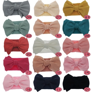 Detailed grid of 15 colorful nylon baby bow headbands with soft ribbed texture