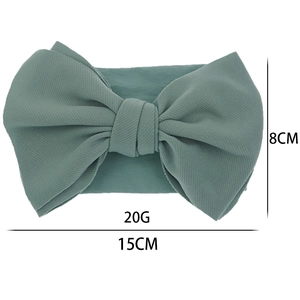 Detailed view of Morandi green knit bow headband showing 15cm width and fabric texture