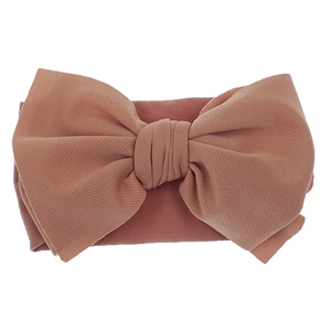 Close-up of soft nylon fabric texture and large bow detail on baby headband