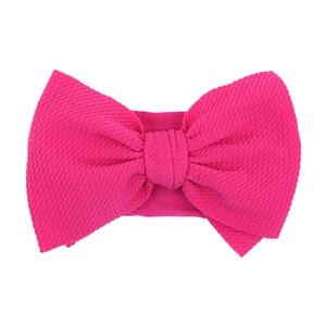 Detailed texture of rose red baby nylon headband with a large decorative bow