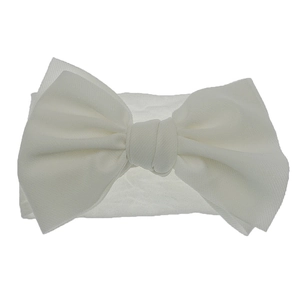 Detailed macro view of white nylon baby headband featuring a soft double-layered bow