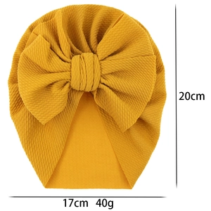 Mustard yellow waffle fabric baby turban hat with a large bow for infants and toddlers