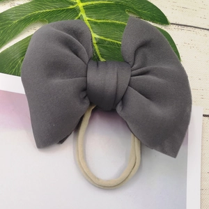 Detail of grey puff bow headband with elastic nylon band for baby girls and infants