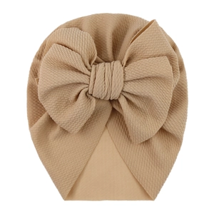 Macro detail of the stretch bubble fabric and large bow on the infant turban hat