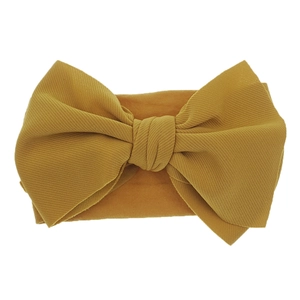 Elastic mustard yellow nylon headband for babies featuring a large textured bow detail
