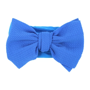 Close-up of royal blue waffle texture fabric and oversized bow detail on infant headband