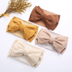 Lot de 4 bandeaux élastiques pour bébé avec grands nœuds aux tons neutres pour filles