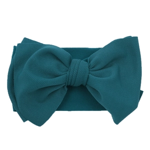 Detailed macro view of dark cyan ribbed knit fabric texture on a baby bow headband