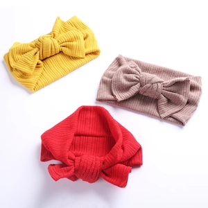 Detailaufnahme von Baby-Strickstirnbändern mit großen Schleifen in Gelb, Rosa und Rot