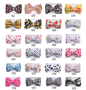 Selection of 24 floral and patterned elastic baby headbands with handmade bows