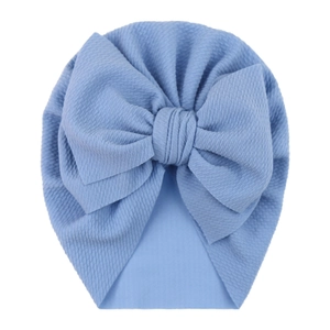 Close-up of light blue bubble fabric baby turban hat with a large bow detail