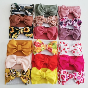 Set of 15 colorful infant bow headbands with floral prints and solid waffle fabric