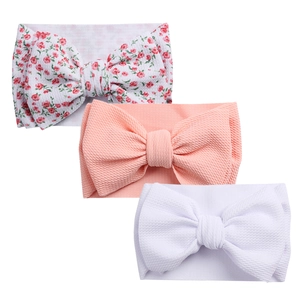 Detailed macro view of soft waffle knit texture on baby bow headbands in three colors