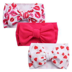Three-piece baby headbands set featuring large bows and waffle knit fabric with prints