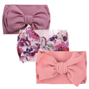 Detailed texture of waffle knit baby bow headbands in solid colors and floral prints