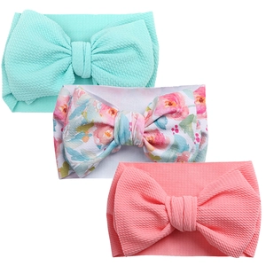 Detailed close-up of 3-piece baby headbands with large bows and waffle knit fabric texture