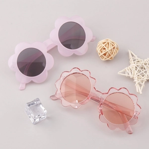 Close-up of flower shaped kids sunglasses in solid and transparent pink frames