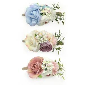 Detailed view of three handmade floral baby headbands with realistic cloth roses and lace