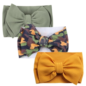 Three-piece baby bow headband set in olive green, camo pattern, and mustard yellow hues