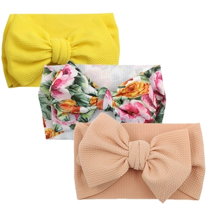 Three-piece baby headband set with large bows in yellow, floral, and pink ribbed fabric