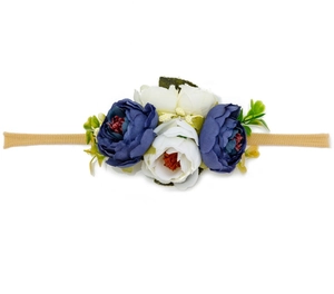 Detail view of handmade artificial navy and white peonies on elastic baby headband
